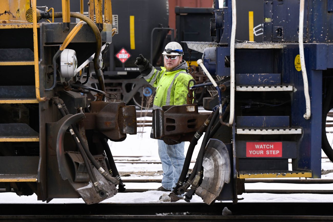 IBEW Local 747 member Peter Flaherty directs an engine at the CSX rail yard in Waterville, Maine.